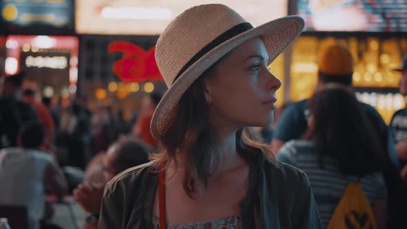 Smiling woman in New York City at night