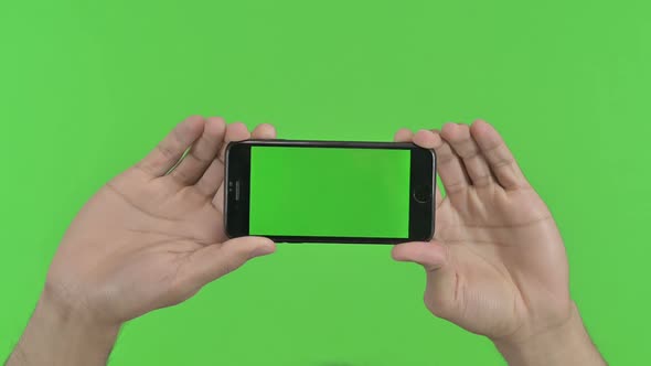 Holding Smartphone Horizontal Green Chroma Key