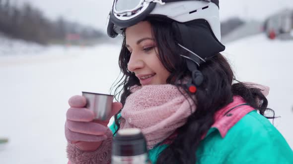 Closeup of Happy Woman Smelling and Drinking Tea at Winter Ski Resort in Slow Motion