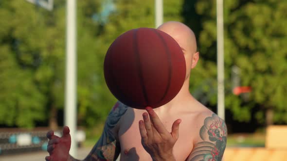 Man With Tattoos Trick Basketball