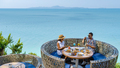 couple having lunch at an restaurant looking out over the ocean of Pattaya Thailand, man and woman - PhotoDune Item for Sale