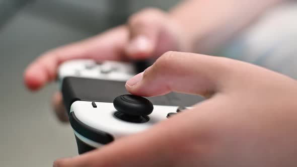 Boy playing video game using joystick, close up