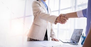 and acquisition,successful negotiate,hand shake,two businessman shake hand with partner to celebration partnership and business deal concept