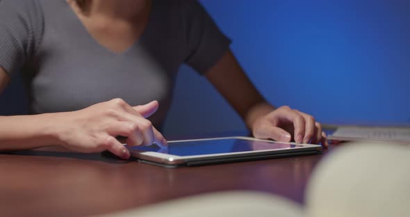 Woman use of tablet computer at home in the evening