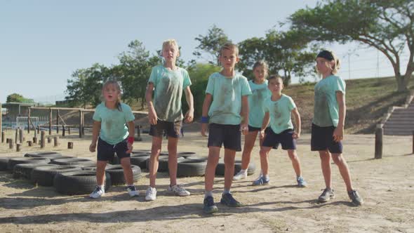 Group of Caucasian children training at boot camp