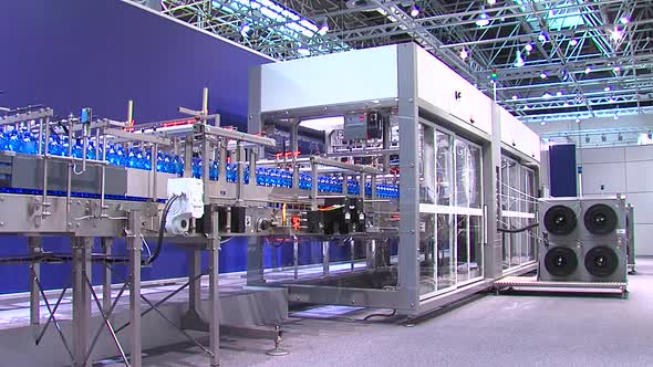 Conveyor At The Enterprise For Dividing Liquids Into White Plastic Bottles