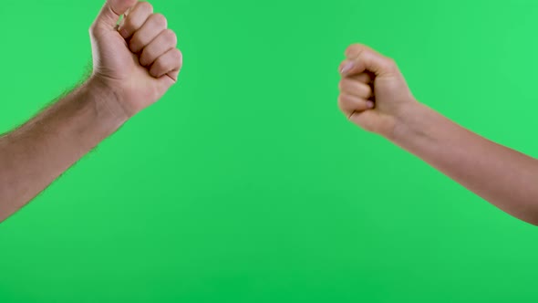 A Woman and a Man Play Rock Paperscissors Several Times Against the Background of the Green Screen