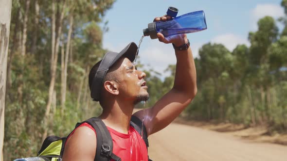 Sporty mixed race man with prosthetic leg drinking water