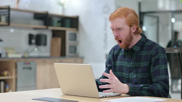 Beard Redhead Man with Laptop Feeling Shocked