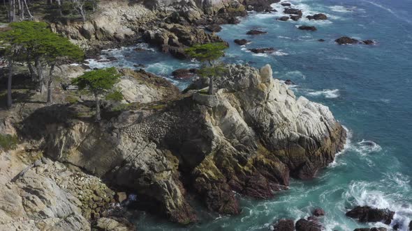 Forward Aerial Pan of Waves Crashing on the Rocky Shores of Big Sur