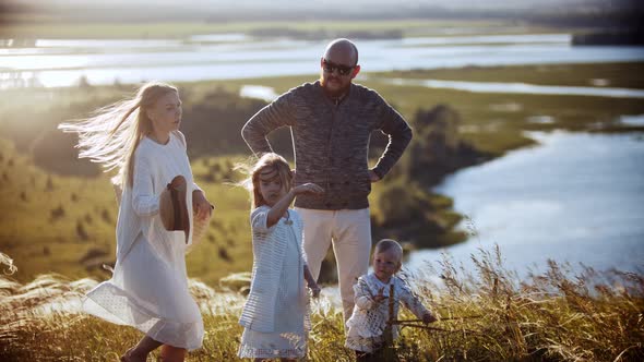 Young Slavic Family Standing on the Wheat Field