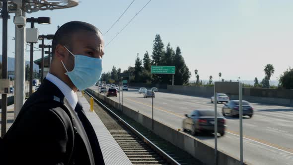 Businessman in a suit waits for a train