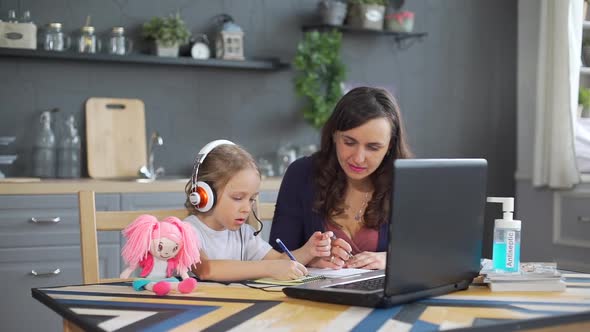 Child Girl Learning Lessons Online with Mother