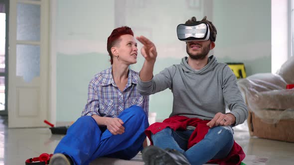 Woman Talking to Man Examining Virtual Design Taking Off VR Headset Smiling
