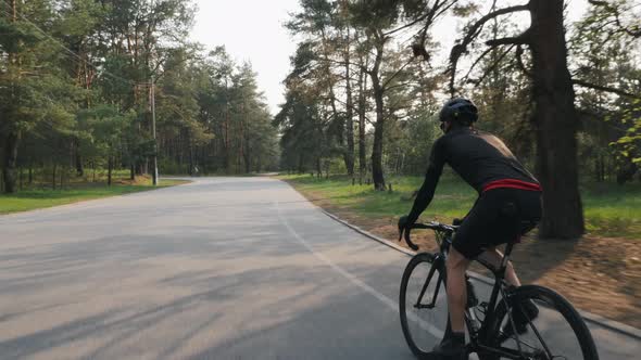 Triathlete riding bicycle in the park training for a race