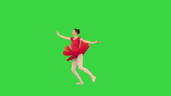 Professional Female Ballet Dancer Doing a Twine Jump on a Green Screen Chroma Key