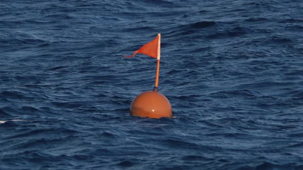 Red Warning Buoy Is Submerged in the Water