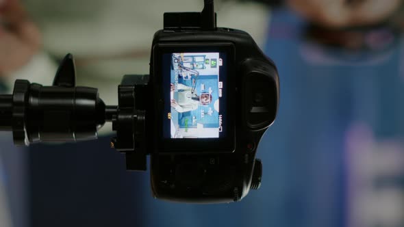 Vertical Video Close Up of Professional Camera Sitting in Front of Dslr Recording