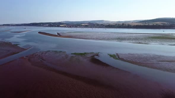 Beautiful landscape view from the sky of coastal town in England. Water plants are visible in the fo