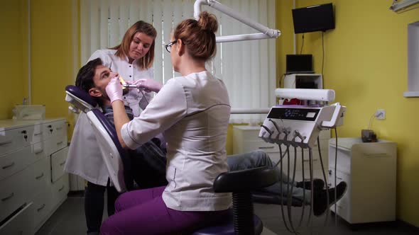 Patient During Teeth Cleaning in Dental Clinic