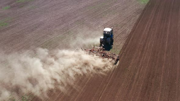 Aerial View of an Agricultural Tractor Passing the Harrow