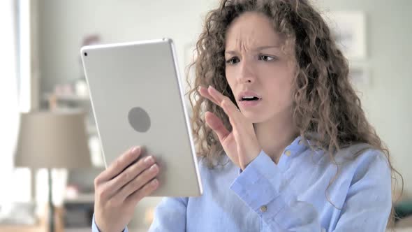 Curly Hair Woman in Shock By Loss While Using Tablet
