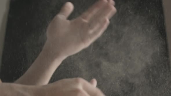 Closeup of Male Hands Shaking Off Flour