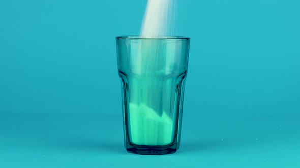 Pour Sugar Green Collins Glass Thick Bottom Blue Contrasting Background. Concept
