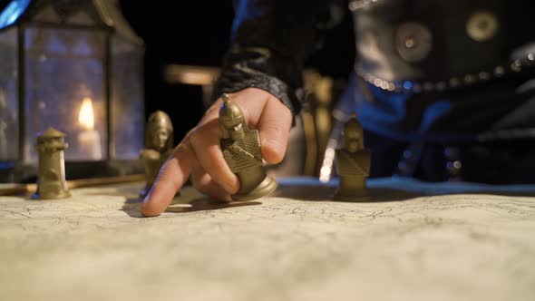 Emperor making plans on the map during the medieval period. alt