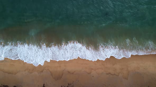 Amazing sea Aerial top view ocean blue waves break on sand beach