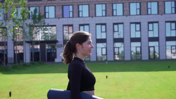 Girl Goes with Mat To Fitness Class