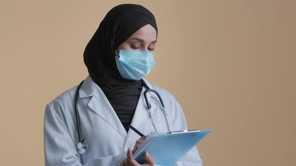 Female Arabian Medical Worker Doctor Muslim Islamic Therapist Wear Safety Mask Hijab Stand in