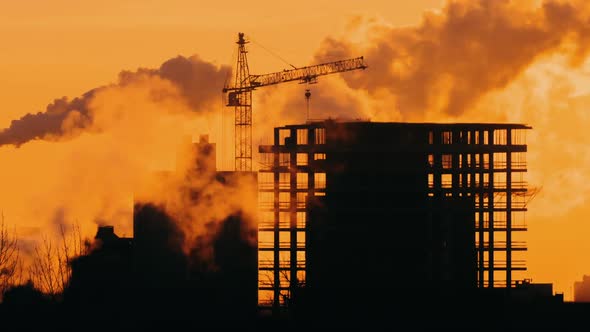 Construction Site Tower Crane Building in the City, Sunrise or Sunset Golden Hour Backlit Silhouette alt