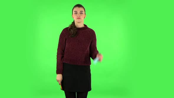 Girl Holding Paper Stick Expressing Awful Mood Then Takes Another Expressing Good Mood. Green Screen