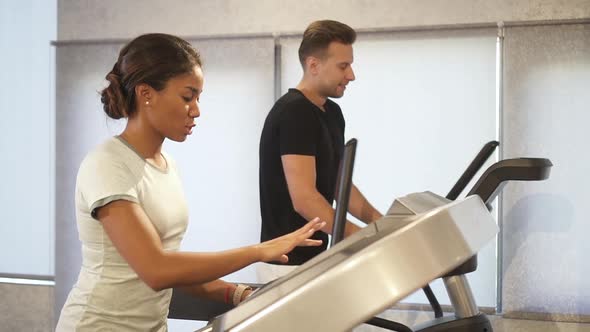 Woman and Man Running on Treadmill Machine