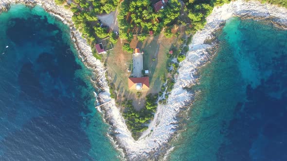 Flying over lighthouse, Croatia with a red tiled roof