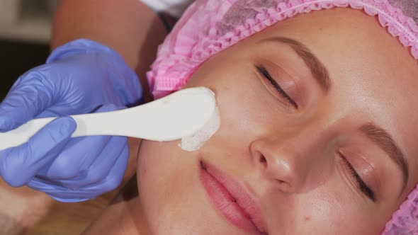 Young Woman Getting Facial Treatment at Cosmetology Salon