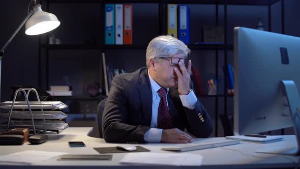 Tired and stressed working man in office