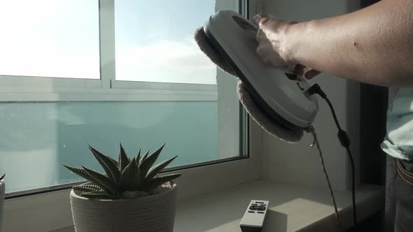 Woman Remote Control of Cleaning Robot