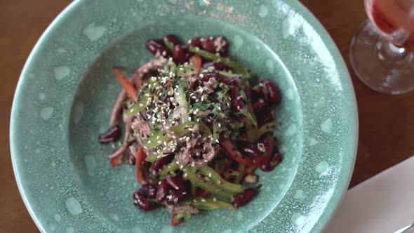 Top view of salad with veal and beans