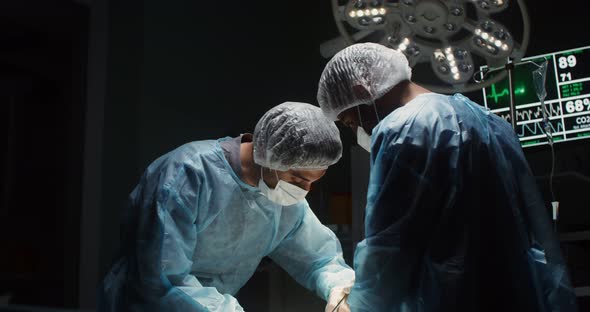 A Team of Surgeons Perform an Operation in a Bright Operating Room