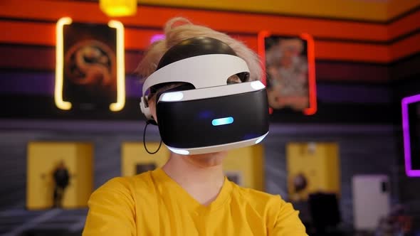 Portrait of a Boy Wearing Virtual Reality Glasses and Hand Motion Controllers