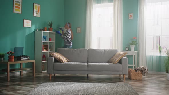 Woman Is Dancing and Taking Care of Houseplants