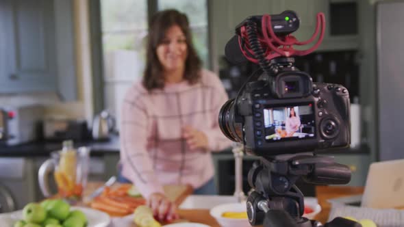 Caucasian vlogger woman doing a cooking video at home