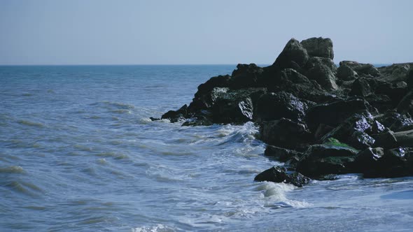 Waves hitting some rocks on the seashore