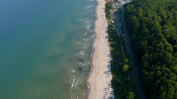 Amazing Aerial Drone Flying Above Tourist Baltic Sea Beach in Scharbeutz Germany Dolly in Day