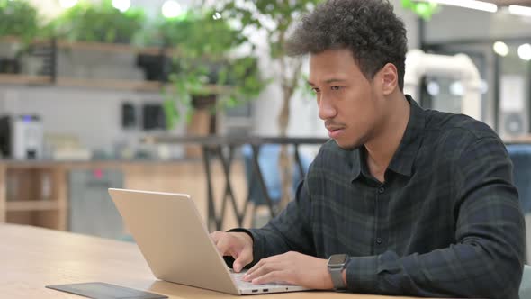 African American Man with Laptop Having Loss Failure