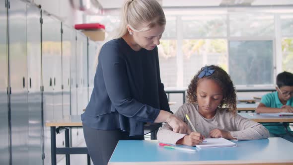 Friendly Female School Teacher Giving Help