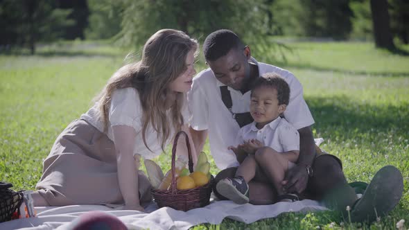 Black Father Fairskinned Mother and Mestizo Child in the Park