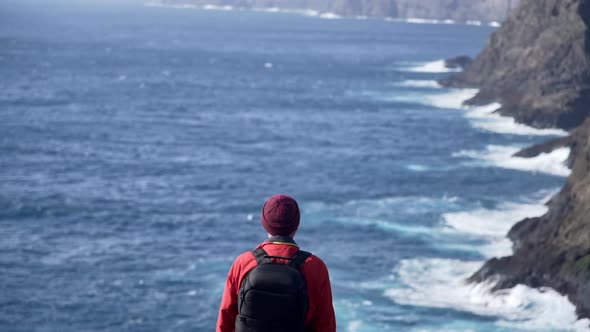 Man Overlooking Dramatic Coastline